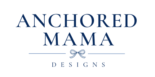 Logo of Anchored Mama Designs with a decorative bow element on a white background